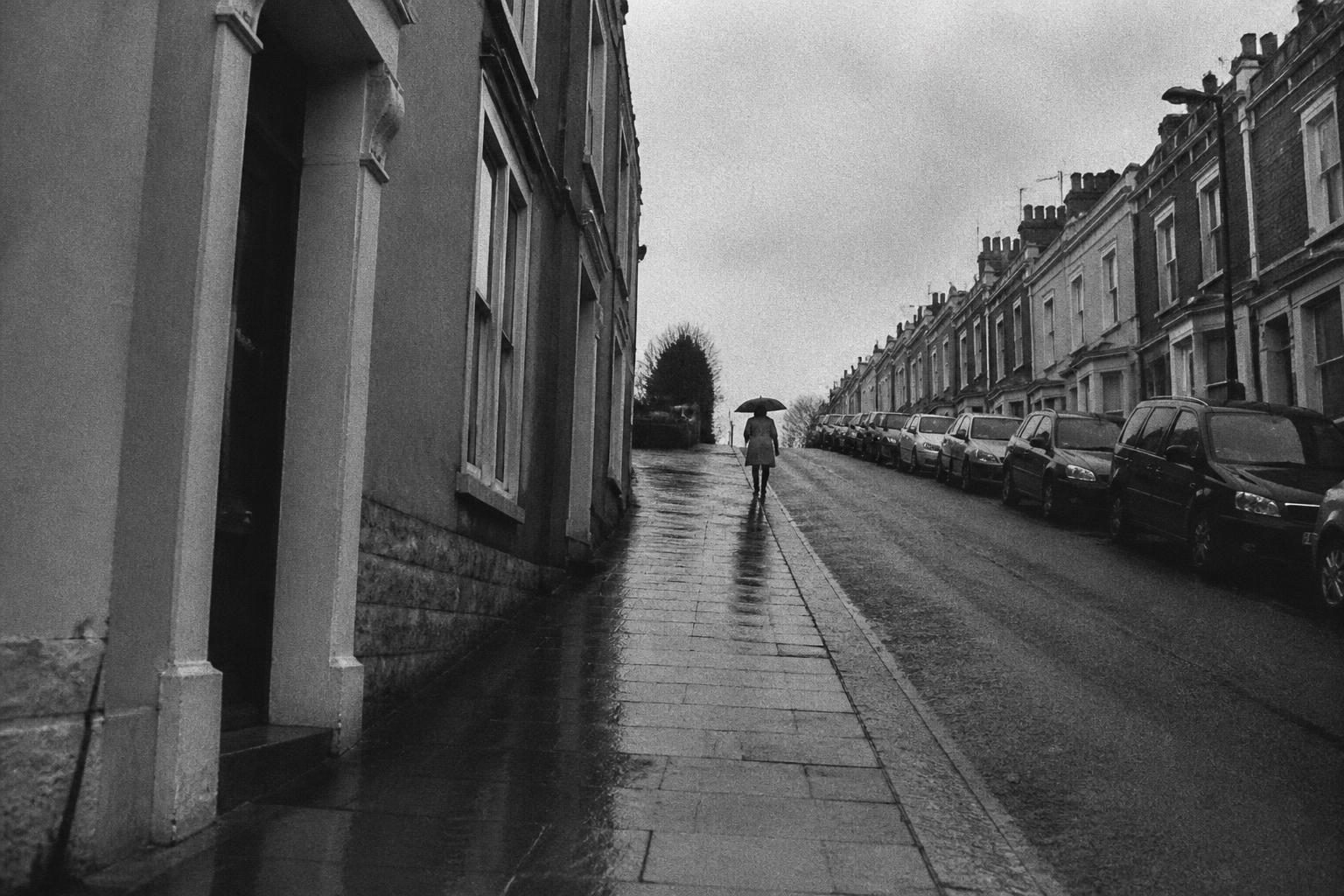 Black and white wet street with reflections and grain