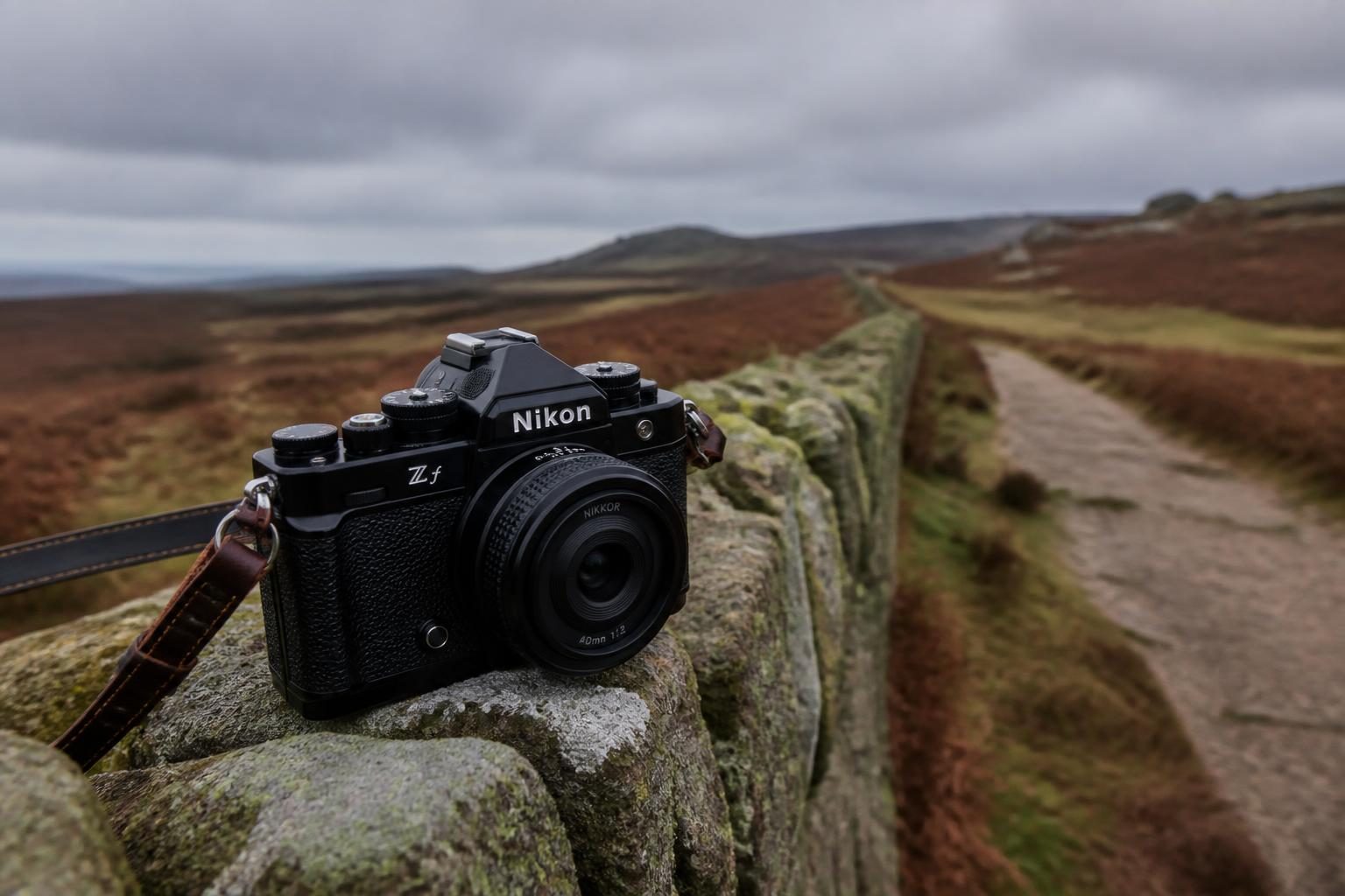 Retro-styled camera with a small lens on a dry stone wall